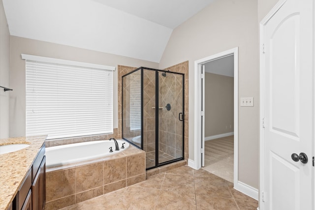 bathroom featuring vanity, independent shower and bath, tile patterned floors, and vaulted ceiling