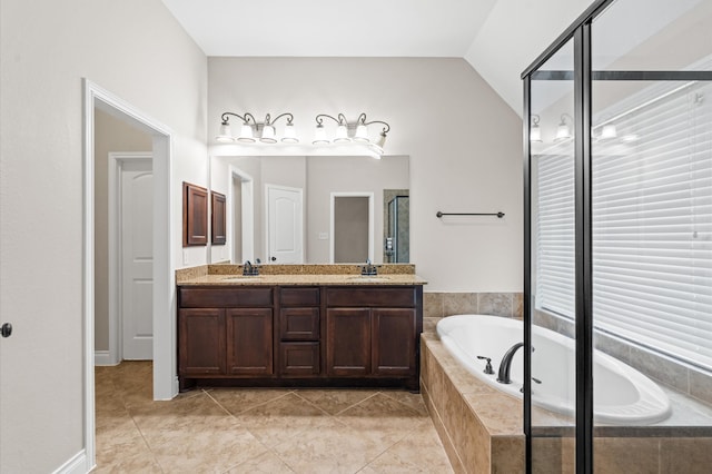 bathroom featuring vanity, tiled bath, tile patterned floors, and vaulted ceiling