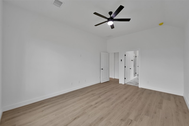 empty room featuring vaulted ceiling, light wood-type flooring, and ceiling fan