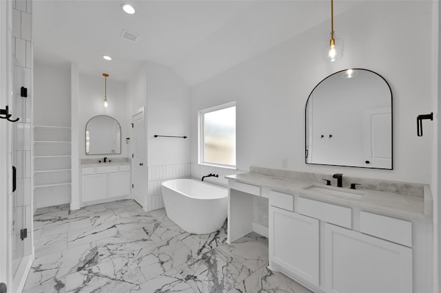 bathroom with a bathtub, lofted ceiling, and vanity