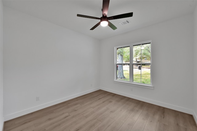 spare room with ceiling fan and light wood-type flooring