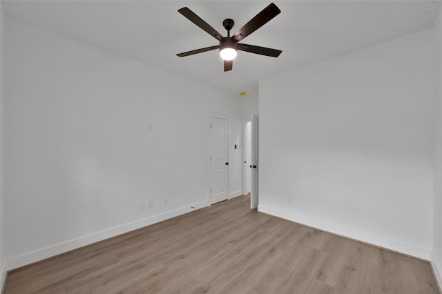 spare room featuring light wood-type flooring and ceiling fan