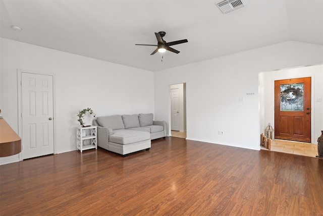 unfurnished living room with dark wood-type flooring, vaulted ceiling, and ceiling fan