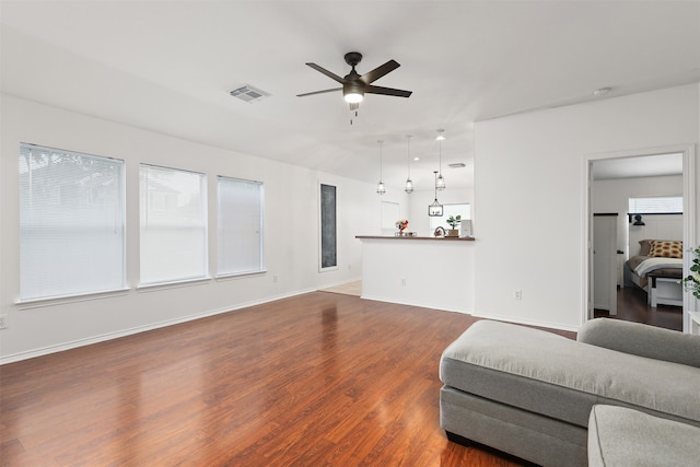 living room with dark wood-type flooring and ceiling fan