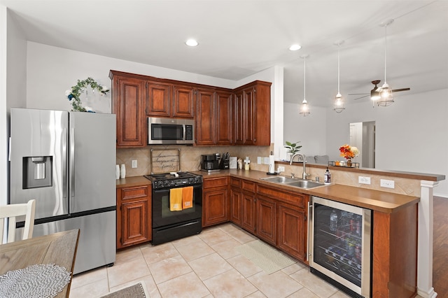 kitchen featuring tasteful backsplash, appliances with stainless steel finishes, sink, kitchen peninsula, and beverage cooler