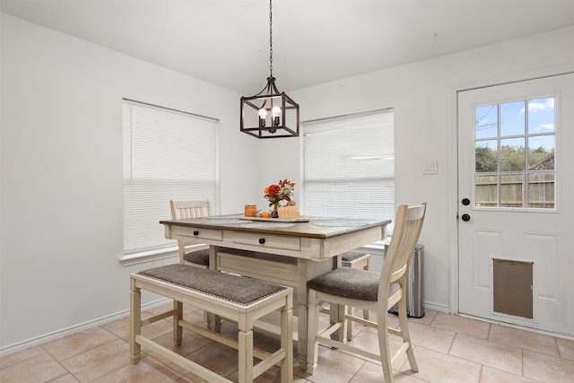 dining room with a notable chandelier and light tile patterned floors