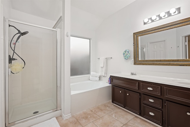 bathroom featuring vanity, independent shower and bath, lofted ceiling, and tile patterned floors