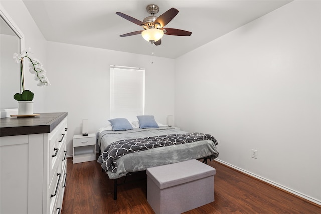 bedroom with dark hardwood / wood-style floors and ceiling fan