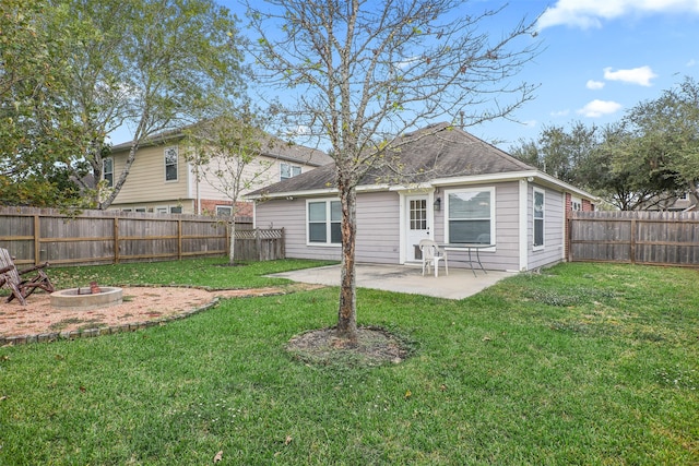 rear view of house featuring a yard and a patio area