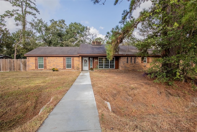 ranch-style home featuring a front yard