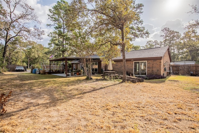 view of front of home with a patio and a front yard