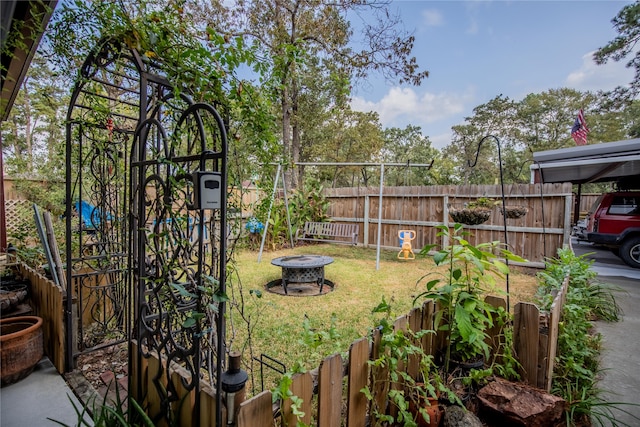 view of yard with a fire pit