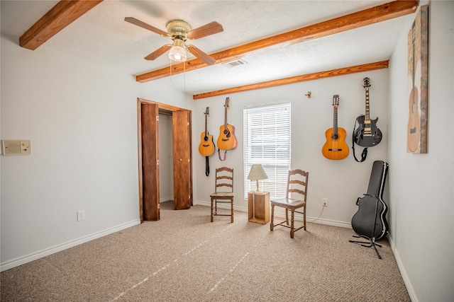 living area featuring carpet floors, beam ceiling, and ceiling fan