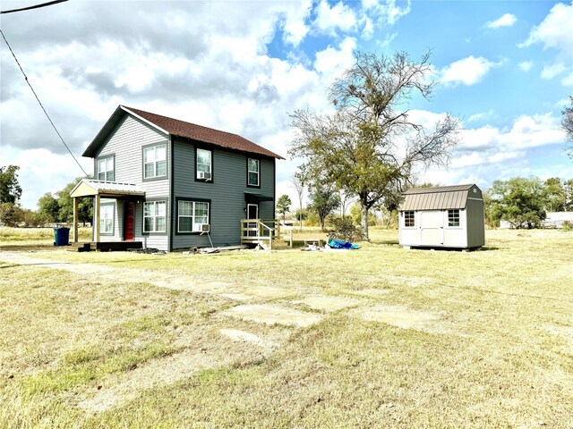 106 E Main St E, Wortham, TX 76693 - back of property with a storage shed, an outdoor structure, and a lawn