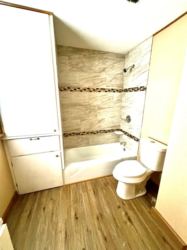 106 E Main St E, Wortham, TX 76693 - bathroom featuring wood finished floors, toilet, and shower / washtub combination