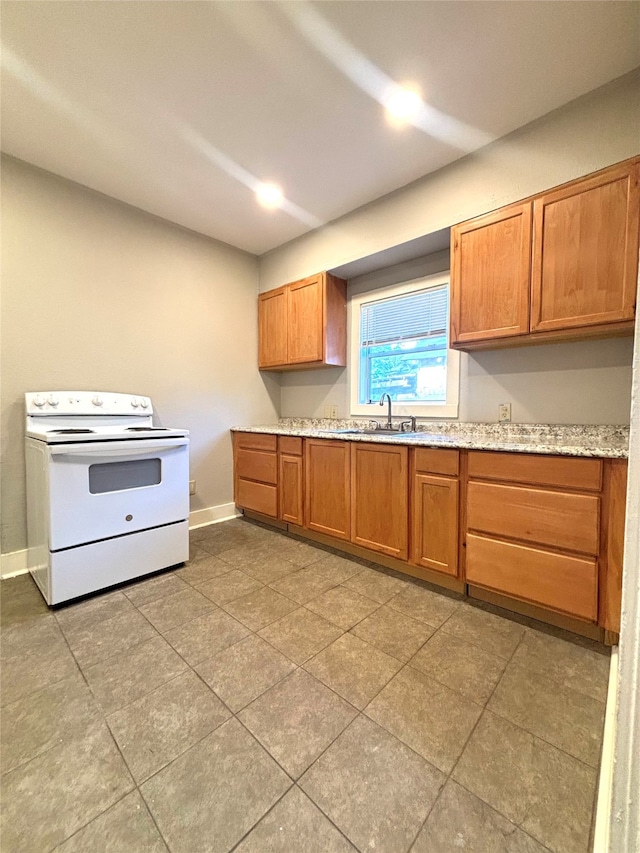 kitchen with light stone countertops, sink, light tile patterned floors, and electric stove