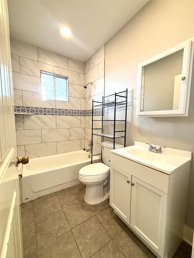 full bathroom featuring vanity, tiled shower / bath combo, toilet, and tile patterned floors