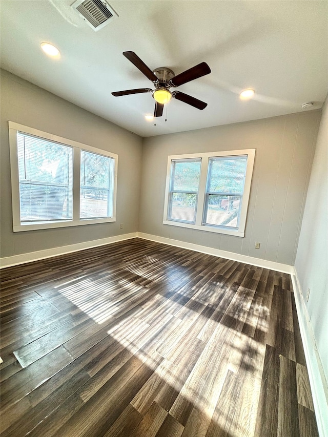 empty room with dark wood-type flooring and ceiling fan