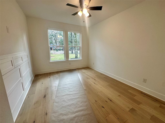 spare room with light hardwood / wood-style floors and ceiling fan