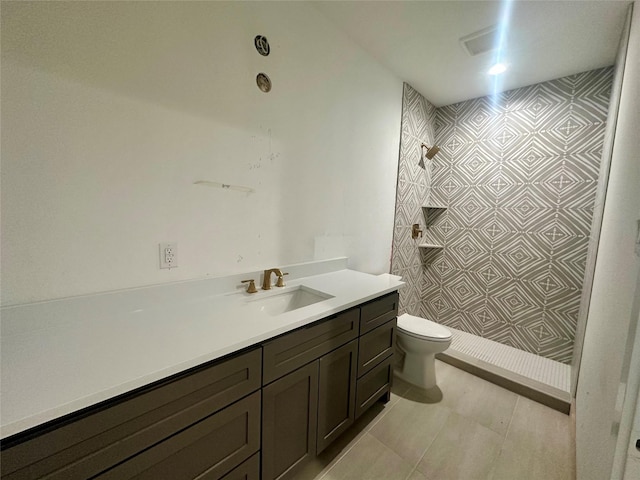 bathroom with toilet, vanity, and walk in shower