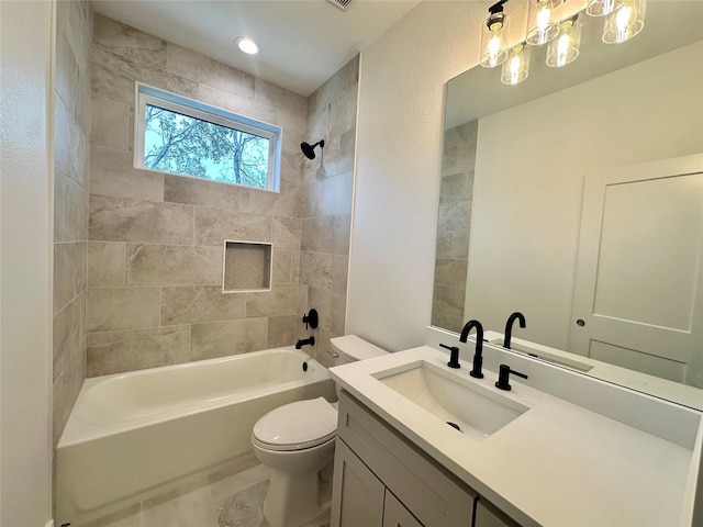 full bathroom with vanity, toilet, and tiled shower / bath