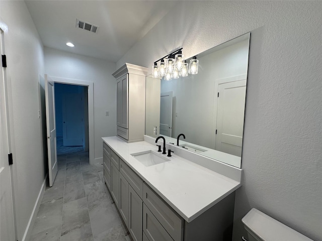 bathroom featuring vanity and toilet