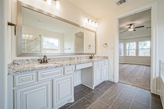 bathroom featuring vanity, ceiling fan, and a shower with shower door