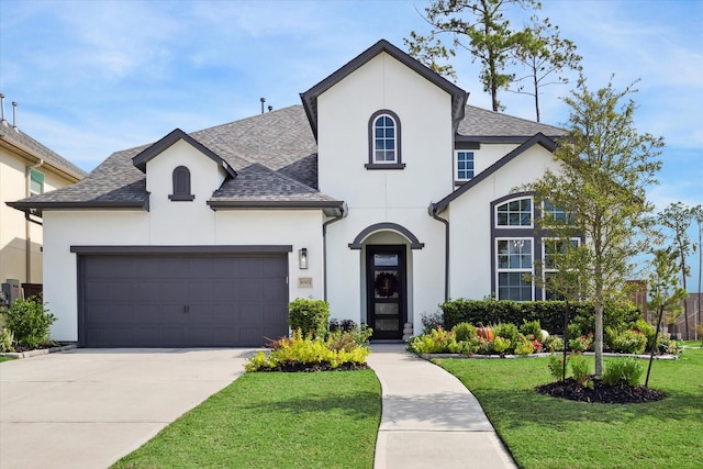 french country home with a garage and a front yard