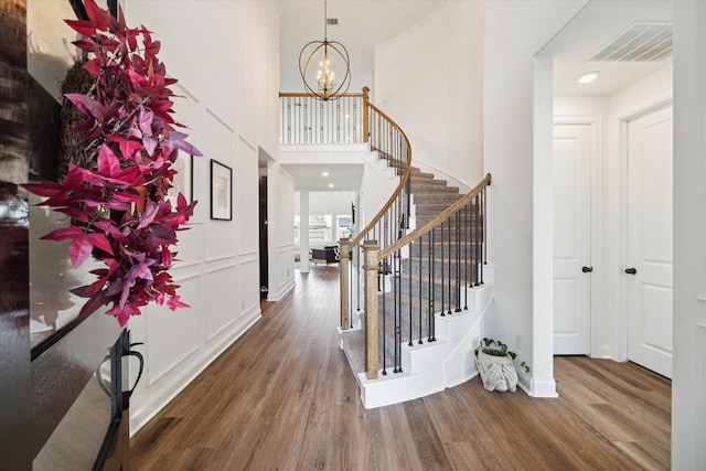 entrance foyer featuring a chandelier and wood-type flooring