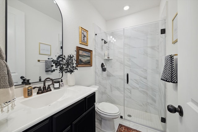 bathroom with a shower with shower door, vanity, toilet, and tile patterned flooring