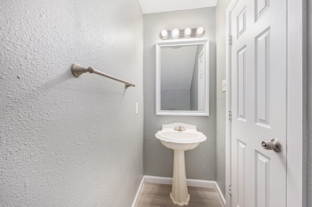 bathroom with hardwood / wood-style flooring