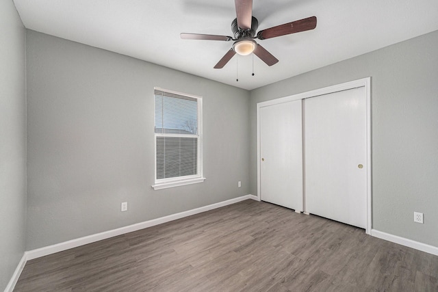 unfurnished bedroom with a closet, ceiling fan, and hardwood / wood-style floors