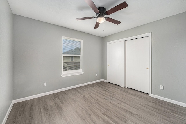 unfurnished bedroom featuring a closet, ceiling fan, and light hardwood / wood-style flooring