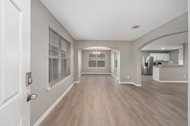 interior space featuring a chandelier and light wood-type flooring