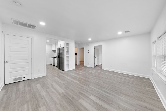 unfurnished living room featuring light wood-type flooring