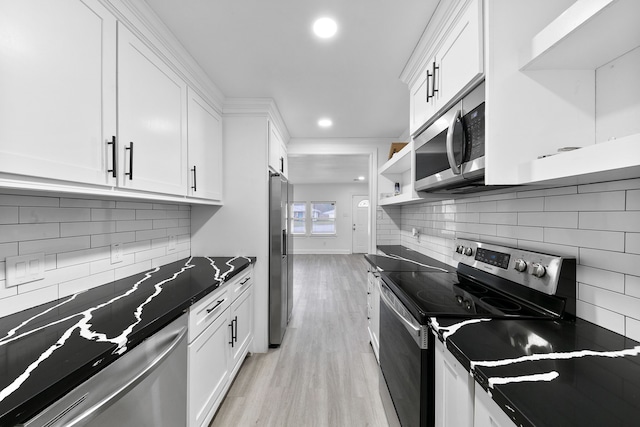 kitchen featuring white cabinetry, appliances with stainless steel finishes, and light wood-type flooring