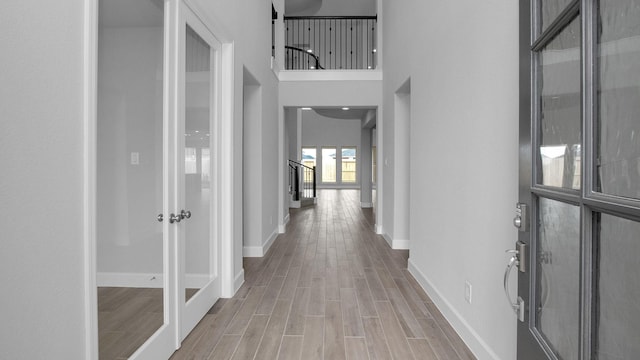 hallway with wood finish floors and baseboards