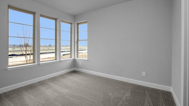 carpeted spare room with baseboards