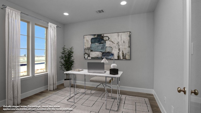 office area with light wood finished floors, recessed lighting, visible vents, and baseboards