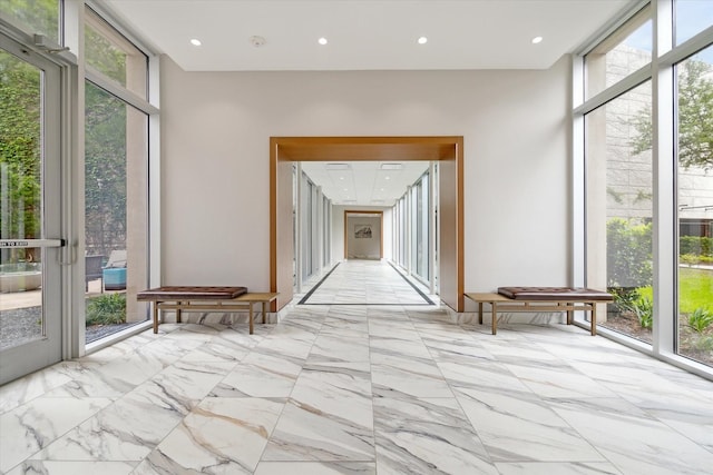 hallway with floor to ceiling windows