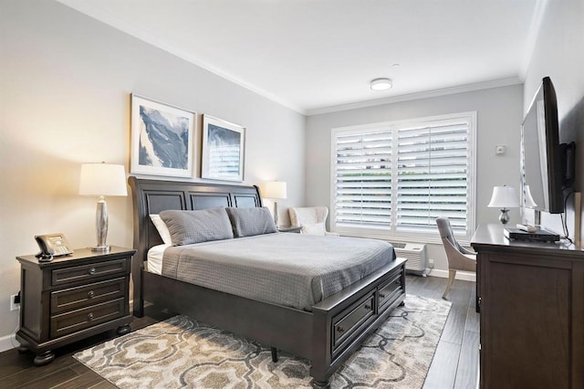 bedroom with dark hardwood / wood-style flooring and crown molding