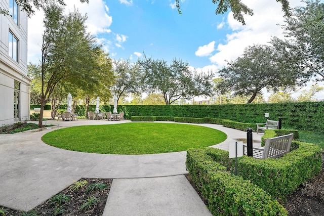 surrounding community with a yard and a patio