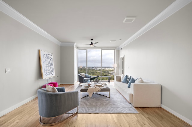 living room with crown molding, light hardwood / wood-style flooring, ceiling fan, and a wall of windows