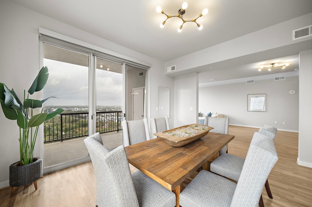 dining area featuring a chandelier and light hardwood / wood-style flooring