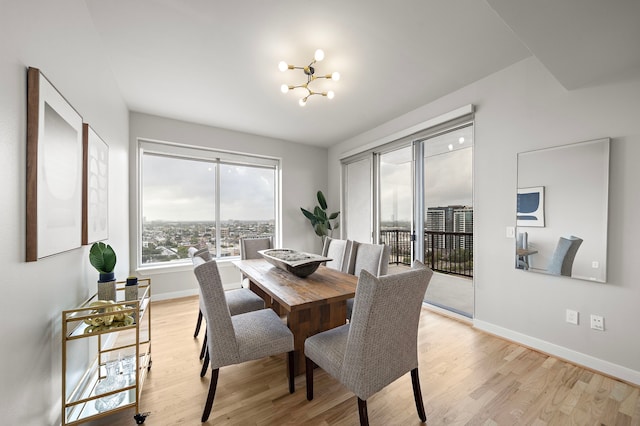 dining area with a chandelier and light hardwood / wood-style floors