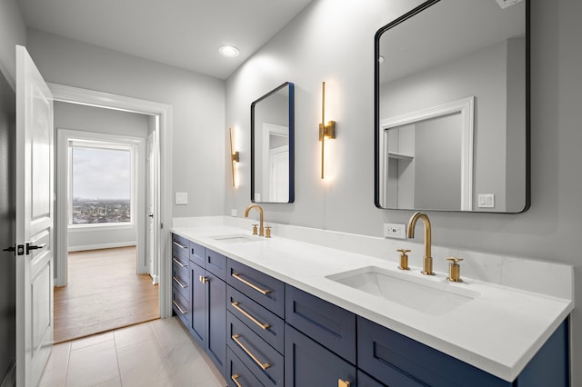 bathroom with tile patterned flooring and vanity