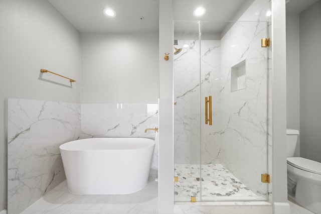 bathroom featuring separate shower and tub, tile walls, and toilet