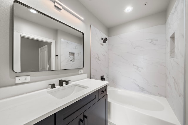 bathroom featuring vanity and tiled shower / bath