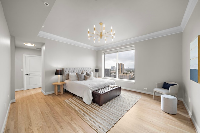 bedroom with a chandelier, light hardwood / wood-style floors, and ornamental molding