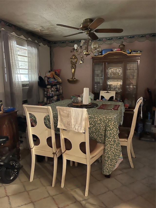 dining area with ceiling fan and a textured ceiling